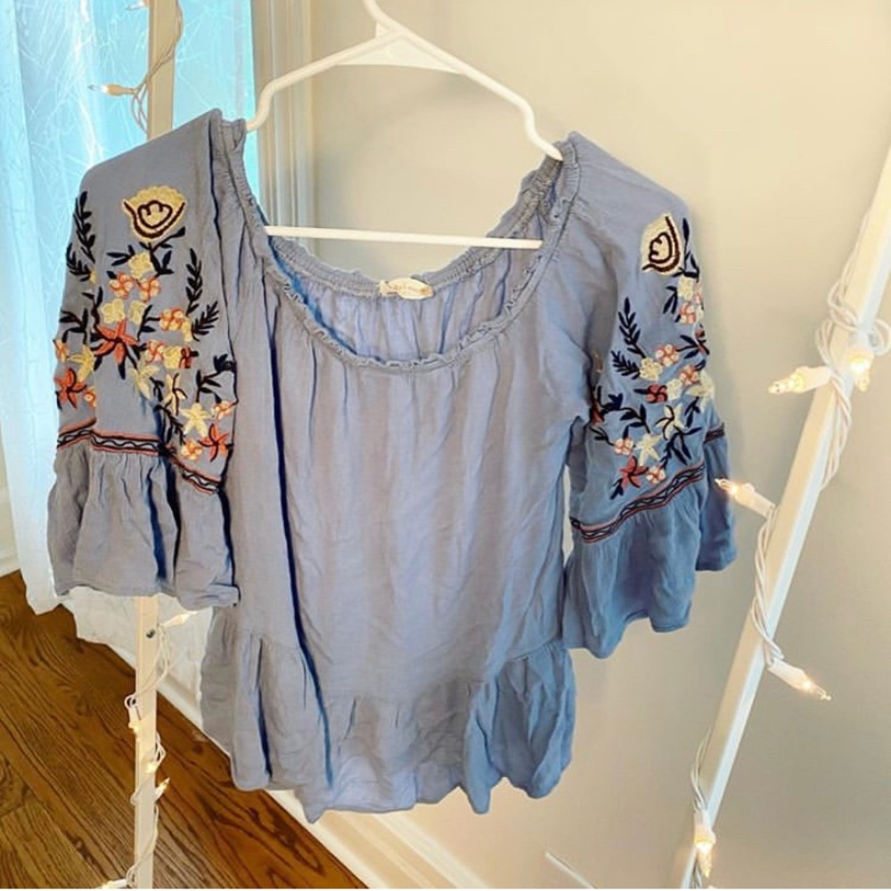 Blue off the shoulder shirt with flowers